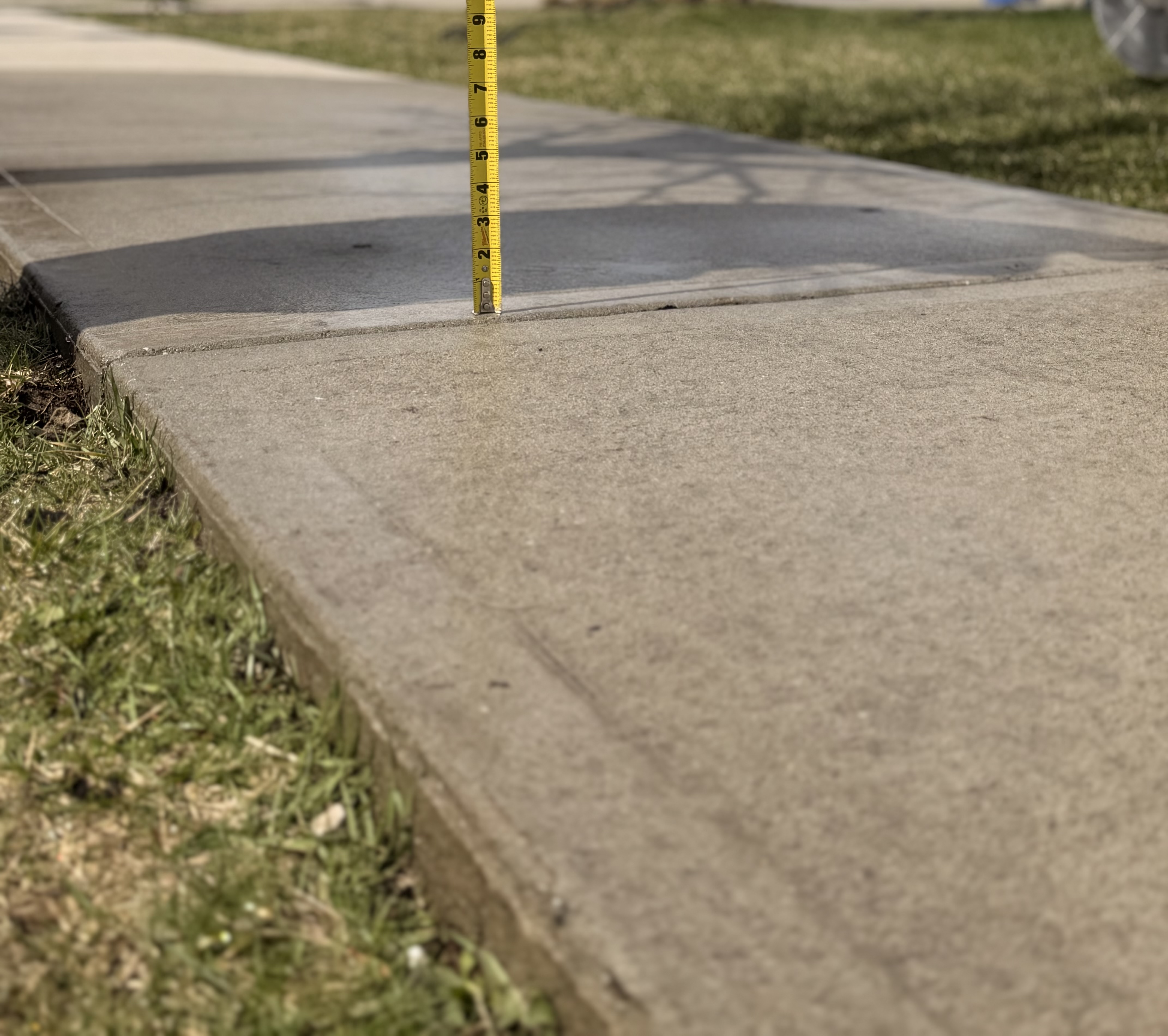 Leveled concrete after lifting - tape measure showing minimal gap